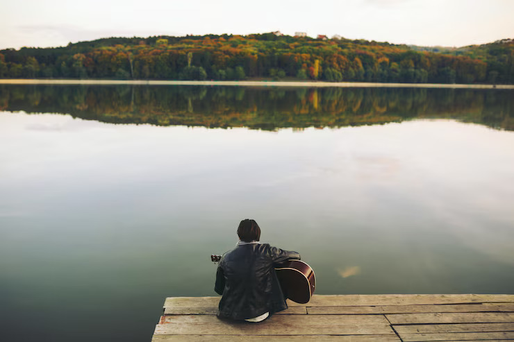 young-man-playing-guitar-lake_158595-2041 young-man-playing-guitar-lake_158595-2041